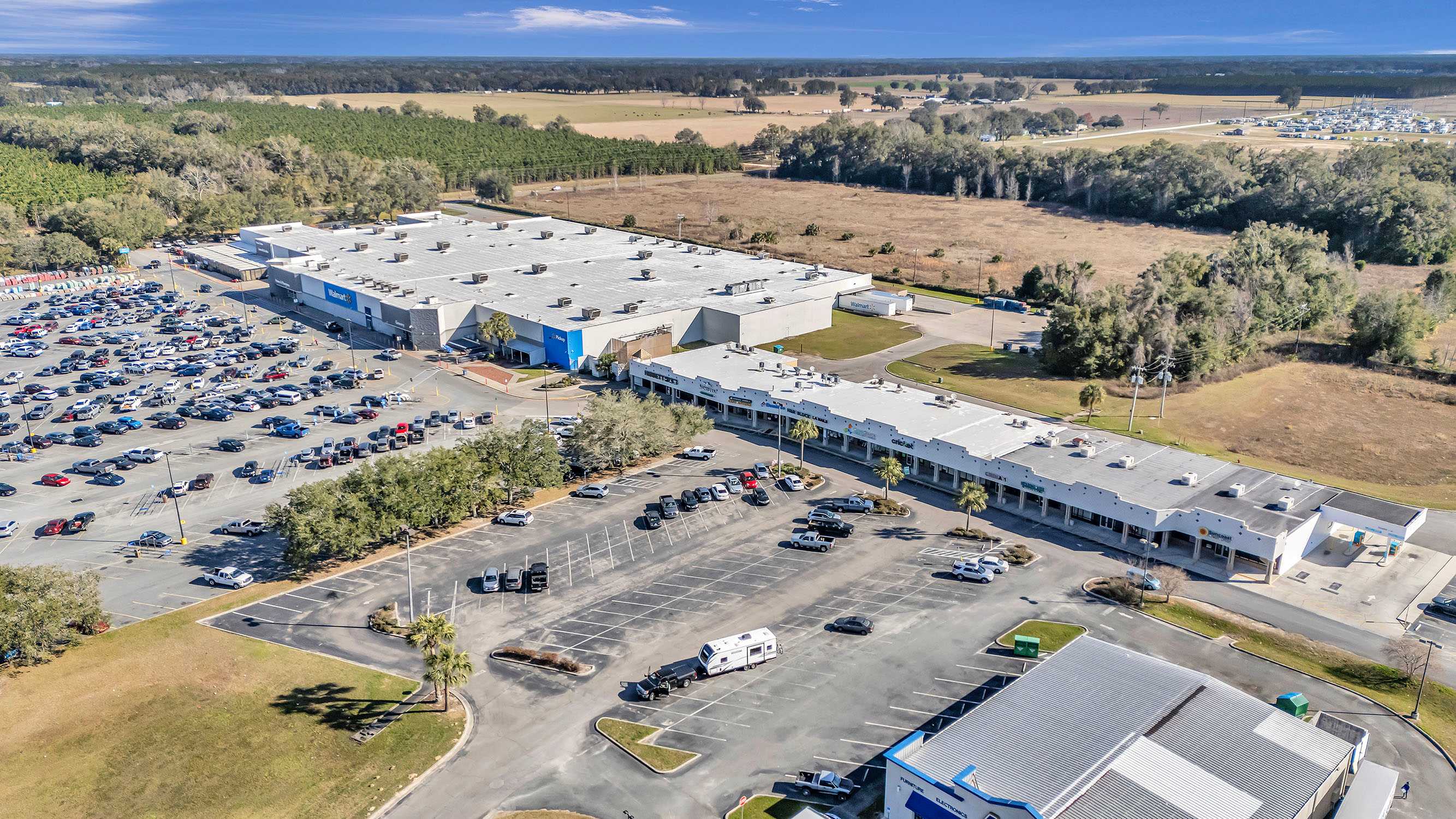 shadow-anchored retail center surrounded by vast land and trees